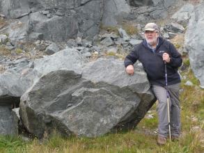 Allen Fraser, local geology expert leaning on diorite, Virdins Quarry, North Mainland